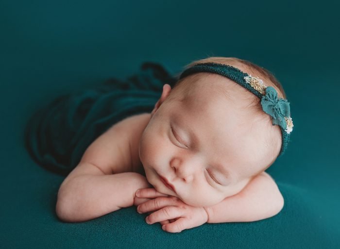 posed newborn photographer in home