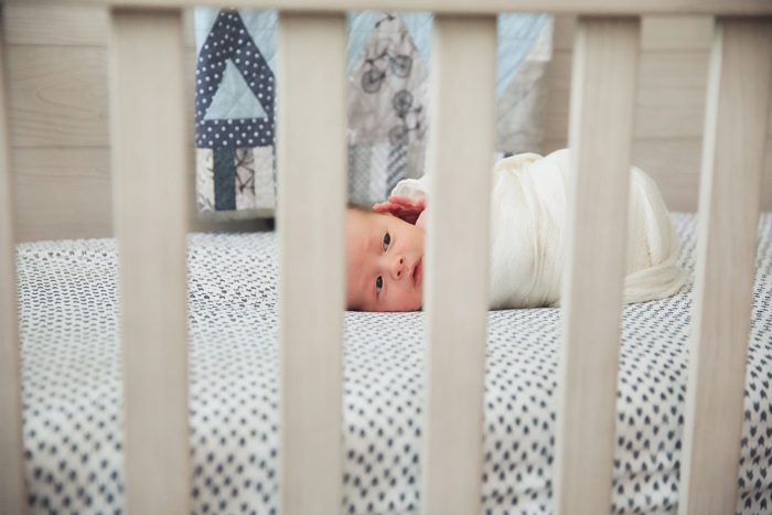 NYC in-home newborn photography session with parents holding their baby in a Manhattan apartment