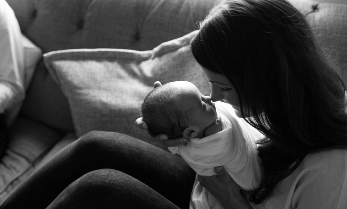 New York City newborn photography client with baby using luxury NYC mom and newborn resources