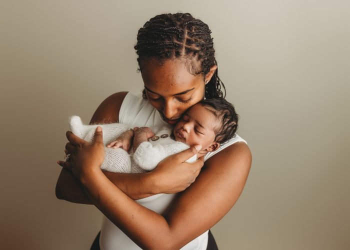 Parents gazing at newborn baby boy during NYC in-home session