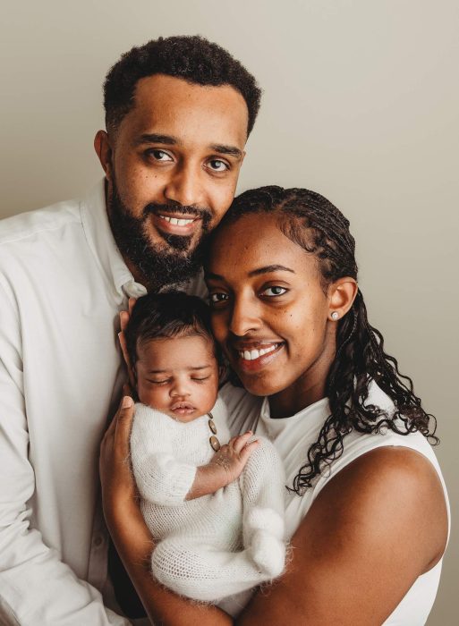 New parents holding their newborn baby boy during NYC newborn photography session