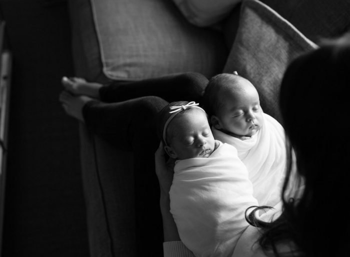 Newborn baby photographed at home in New York City with mom nearby