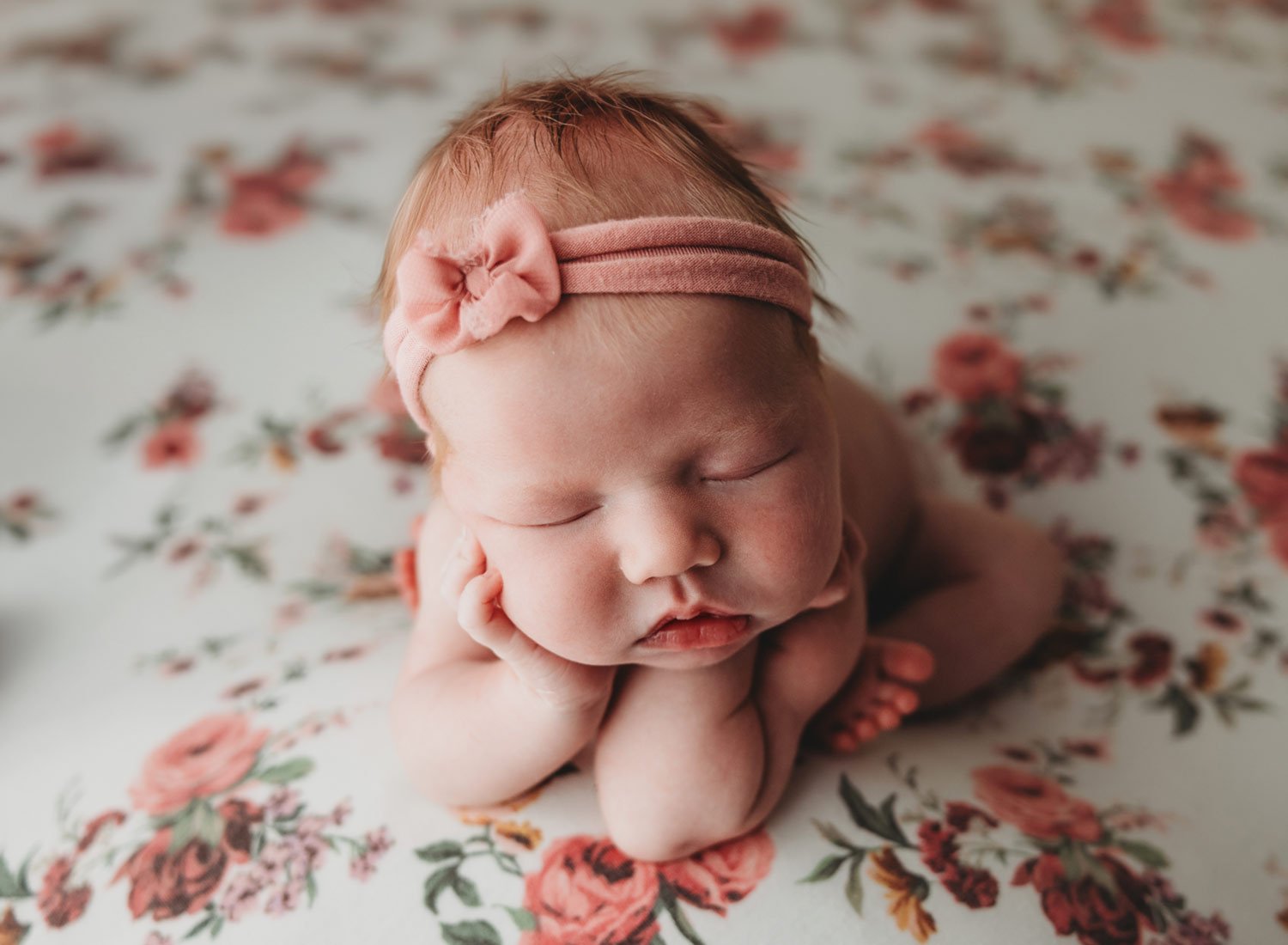 newborn baby girl on flowered blanket in the froggy pose. Rye New york baby photography