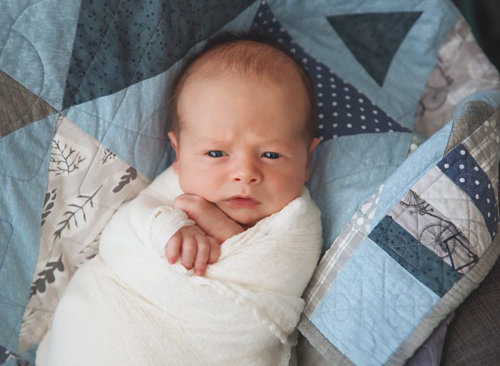 Editorial-style newborn photography in a NYC apartment using natural light