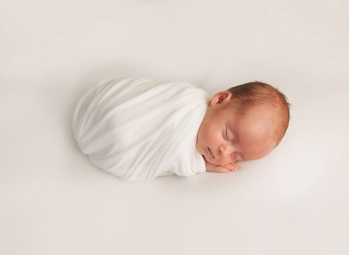 Minimalist newborn photography session in New York with neutral styling