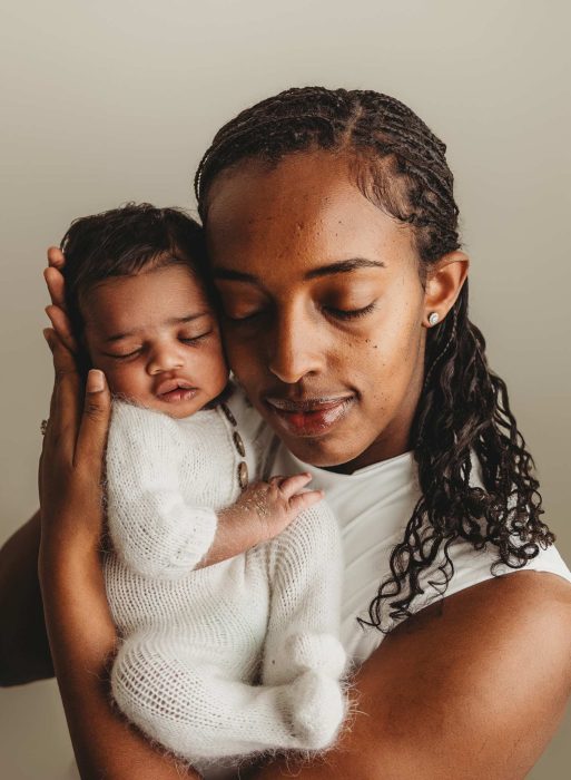 Parents gazing at newborn baby boy during NYC in-home session