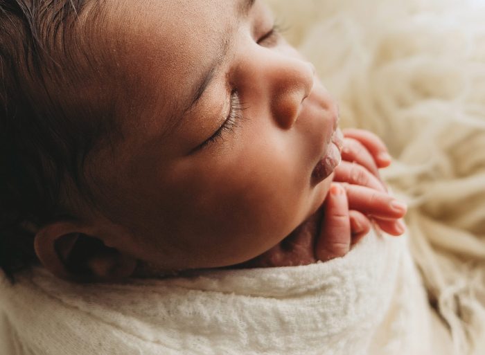 Authentic lifestyle newborn photography of baby boy with parents in NYC