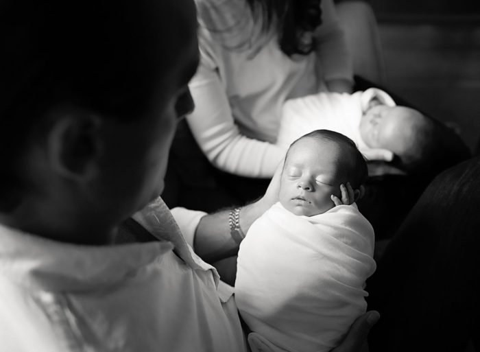 Brooklyn in-home newborn photography session with parents holding their baby