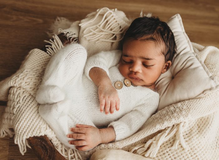 Baby boy wrapped in neutral tones photographed in NYC apartment newborn session