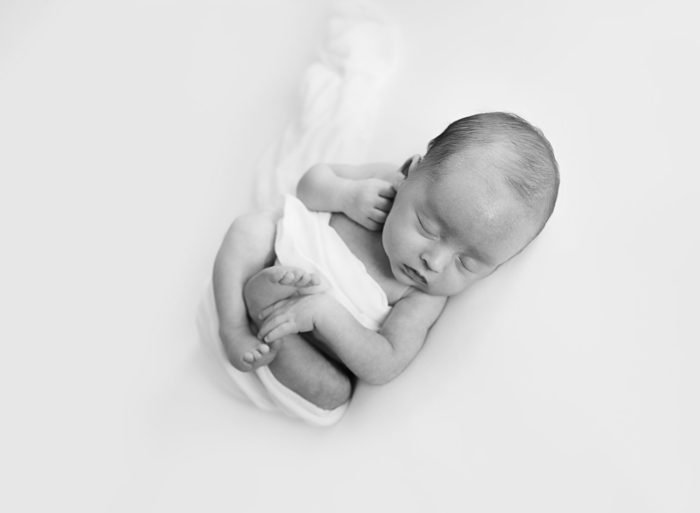 Luxury newborn photographer capturing a calm in-home session in NYC