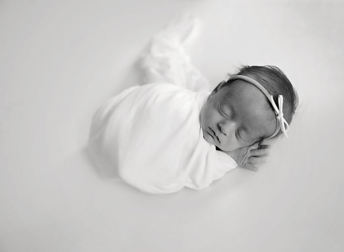 In-home newborn photography session in New York City with baby peacefully sleeping