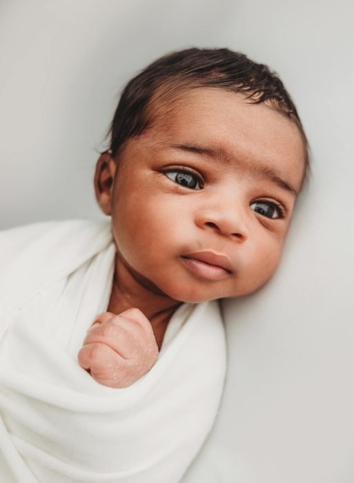 Newborn baby boy posed safely during in-home NYC newborn session