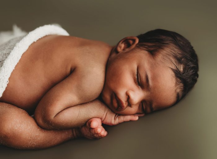 Newborn baby boy sleeping during an in-home newborn photography session in New York City