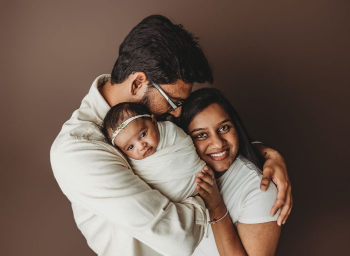 camas newborn photographer of family in brown wearing white.